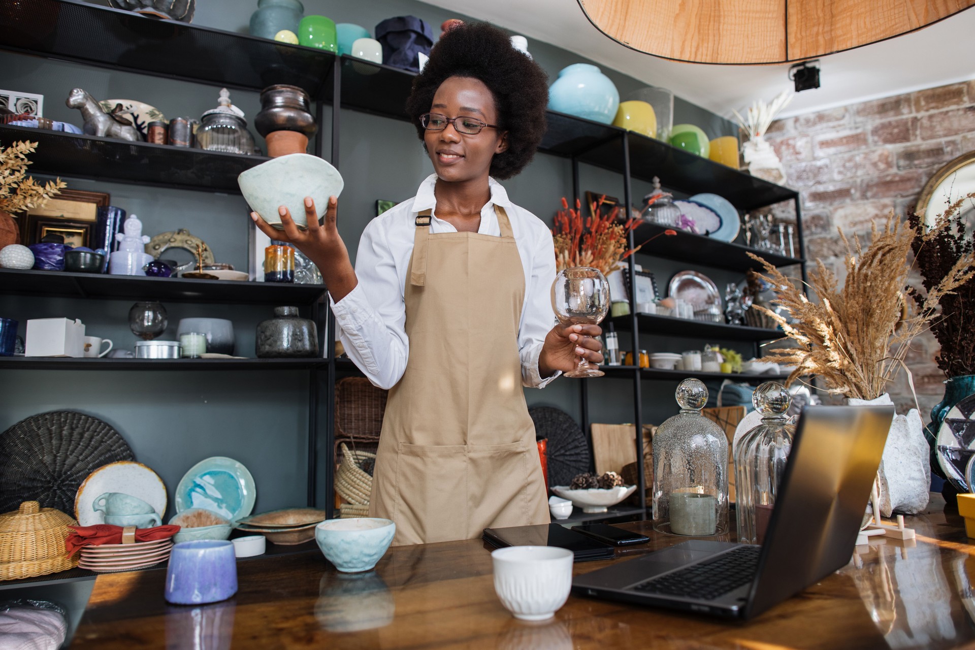 Afro american woman using laptop for receipting of goods